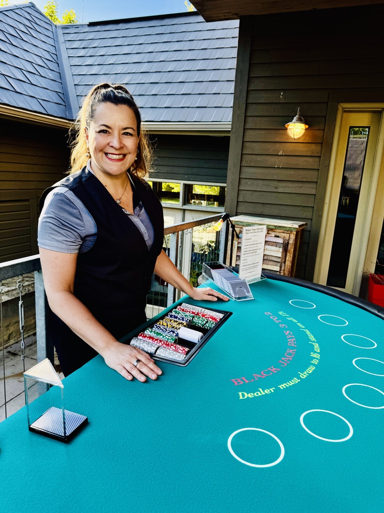 Elan smiling at the camera at her blackjack table
