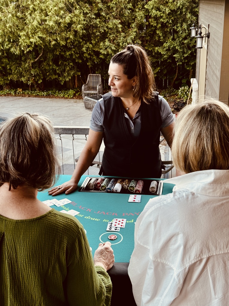 Elan at the table looking aside while players play